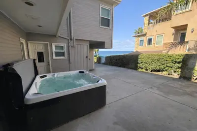 a hot tub on a sidewalk in front of a house at F-76 Terramar Cliffs in Carlsbad