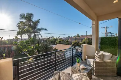 a balcony with chairs and a view of the ocean at Walk to the Beach Luxury Roof Deck Sunset View in Oceanside