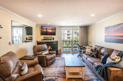 a living room with leather furniture and a fireplace at Walk to the Beach Pool & Hot Tubs & Gym - A-116 in Oceanside