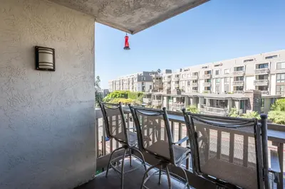 a balcony with chairs and a view of a building at Walk to the Beach Pool & Hot Tubs & Gym - A-116 in Oceanside