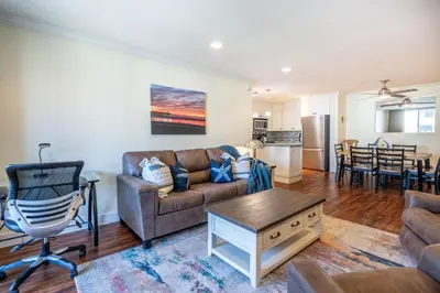 a living room with a couch and a table at Walk to the Beach Pool & Hot Tubs & Gym - A-116 in Oceanside