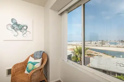 a room with a window with a view of the ocean at Penthouse Ocean & Sunset Balcony Views - G-323 in Oceanside