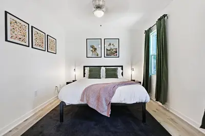 a white bedroom with a bed and a window at Luxury Home with Spacious Backyard - Sleeps 12 in Poway