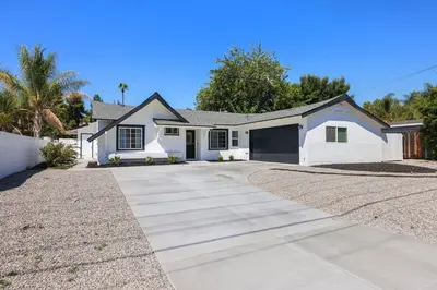 a white house with a driveway at Luxury Home with Spacious Backyard - Sleeps 12 in Poway