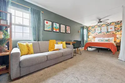 a living room with a couch and a bedroom at 10 Mins to the Beach La Jolla and UCSD in San Diego
