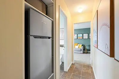 a refrigerator in a hallway with a living room at 10 Mins to the Beach La Jolla and UCSD in San Diego