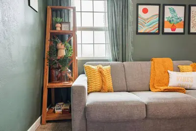 a living room with a gray couch with yellow pillows at 10 Mins to the Beach La Jolla and UCSD in San Diego
