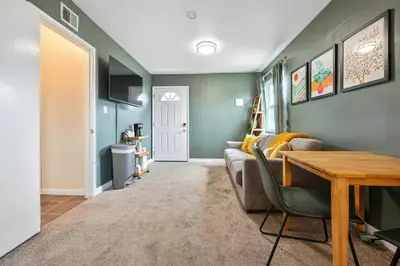 a living room with a couch and a table at 10 Mins to the Beach La Jolla and UCSD in San Diego
