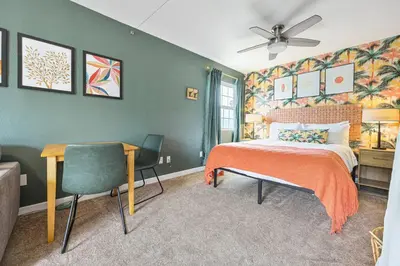 a bedroom with a bed and a desk and a chair at 10 Mins to the Beach La Jolla and UCSD in San Diego