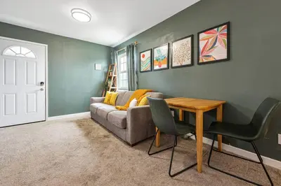a living room with a couch and a table at 10 Mins to the Beach La Jolla and UCSD in San Diego