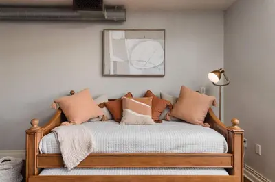 a bedroom with a wooden bed with pillows on it at Upscale Modern Spacious Loft in Little Italy in San Diego