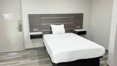 a bedroom with a large bed in a room at Broadway Inn and Suites in Chula Vista