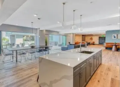 a large kitchen and living room with a table and chairs at Lux North Park Gem King Beds Workspaces Parking in San Diego