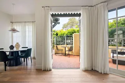 a living room with a door open to a patio at 3BR La Jolla Village Walk to Beach in San Diego