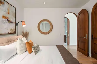 a bedroom with a white bed and a mirror at 3BR La Jolla Village Walk to Beach in San Diego