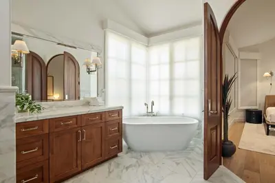 a bathroom with a tub and a large mirror at 3BR La Jolla Village Walk to Beach in San Diego