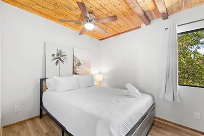 a bedroom with a bed and a ceiling fan at Stunning Bay Views with Pickleball and Hot Tub in San Diego