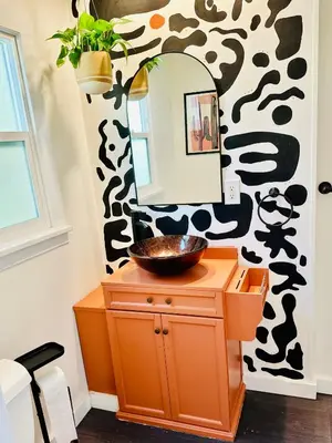 a bathroom with a sink and a mirror on a wall at Casa Luna in San Diego