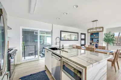a kitchen with white walls and a large counter top at Tower 9 Oceanview House in Oceanside