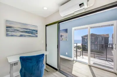 a room with a desk and a view of the ocean at Tower 9 Oceanview House in Oceanside