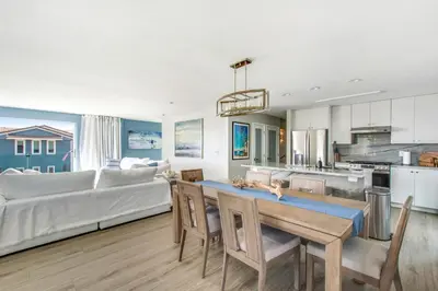 a kitchen and living room with a couch and a table at Tower 9 Oceanview House in Oceanside