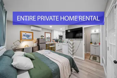 a small bedroom with a bed and a kitchen at Entire Private Studio with 1 King Bed, Full Kitchen, Gated Yard, Available Now in Spring Valley