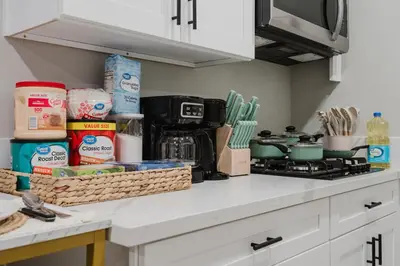 a kitchen counter with a stove and some food at Entire Private Studio with 1 King Bed, Full Kitchen, Gated Yard, Available Now in Spring Valley