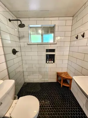 a bathroom with a toilet and a sink and a window at Urban Oasis Near Downtown & Balboa Park in San Diego