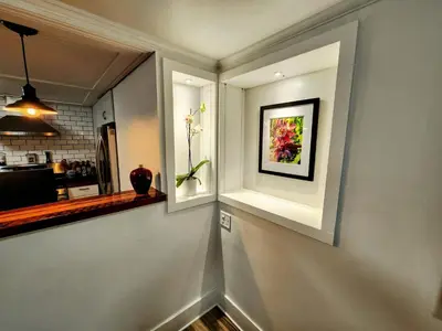 a hallway with a white wall with a picture on it at Urban Oasis Near Downtown & Balboa Park in San Diego