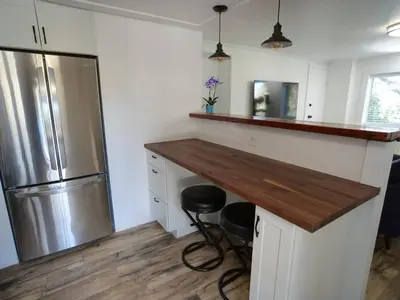 a kitchen with a counter and a refrigerator at Urban Oasis Near Downtown & Balboa Park in San Diego