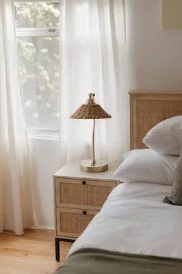 a lamp on a night stand next to two beds at Designer Bungalow Steps to Beach in San Diego