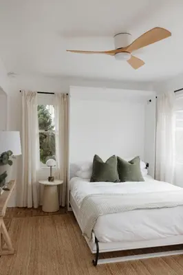 a bedroom with a white bed with a ceiling fan at Designer Bungalow Steps to Beach in San Diego