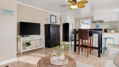 a living room with a kitchen and a dining room at The Edgewater Condos by AvantStay in Newport Beach