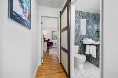 a bathroom with a toilet and a tile wall at Nature-Inspired Stay with Pool, Fire Pits and More in El Cajon
