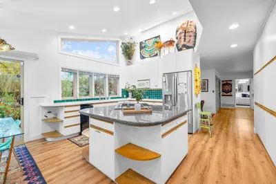 a kitchen with white cabinets and a large island at Nature-Inspired Stay with Pool, Fire Pits and More in El Cajon