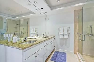 a bathroom with a sink and a glass shower at Pool, Hot Tub, Steps To Omni La Costa in Carlsbad