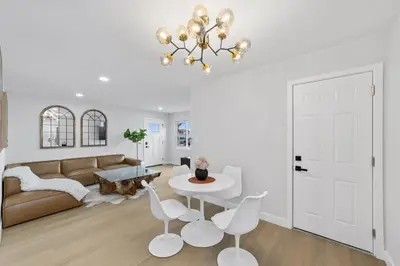 a living room with a couch and a table and chairs at NEW 2BR, 1BA, Outdoor Fireplace, Patio Lounge, Western Vibes, Smart TVs, Ambient Lighting in San Diego