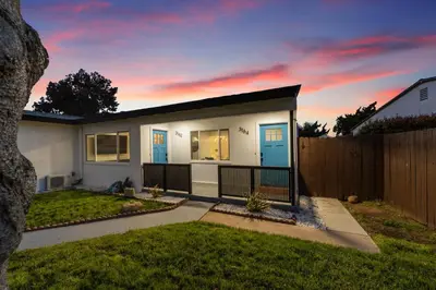 a small white house with a fence at NEW 2BR, 1BA, Outdoor Fireplace, Patio Lounge, Western Vibes, Smart TVs, Ambient Lighting in San Diego
