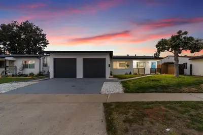 a house with a garage on a driveway at NEW 2BR, 1BA, Outdoor Fireplace, Patio Lounge, Western Vibes, Smart TVs, Ambient Lighting in San Diego