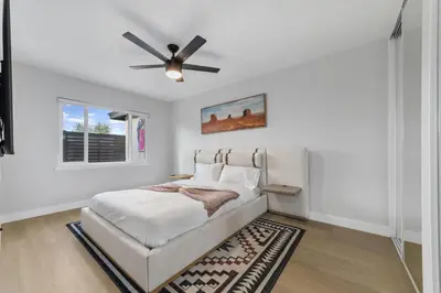a white bedroom with a bed and a ceiling fan at NEW 2BR, 1BA, Outdoor Fireplace, Patio Lounge, Western Vibes, Smart TVs, Ambient Lighting in San Diego