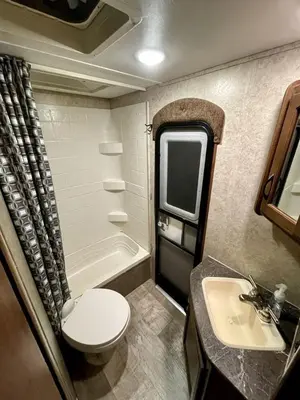 a small bathroom with a toilet and a sink at Cozy Camper with Fire Pit and Beautiful Sunsets in California in Temecula