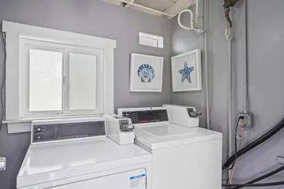 a kitchen with white appliances and a window at Ocean VIEWS Steps from Victoria Beach Lux Design in Laguna Beach