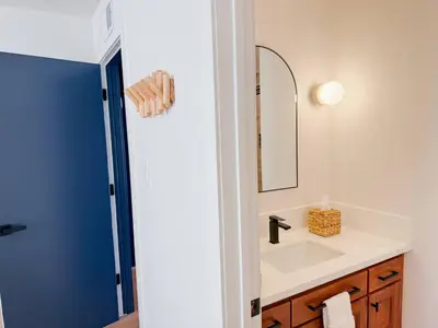 a bathroom with a sink and a mirror at Fully Renovated Beachfront Surf House Oceanside in Oceanside