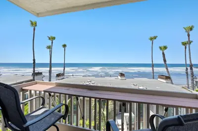 a balcony with a table and chairs and the beach at D213 - Seaview Beach House in Oceanside