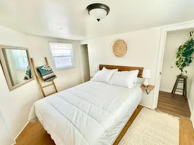 a bedroom with a large white bed in it at Casa Sol in San Diego