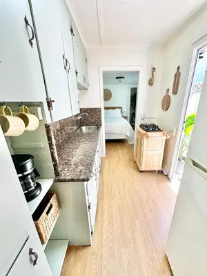 a kitchen with marble counter tops and a bedroom at Casa Sol in San Diego