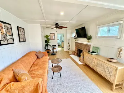 a living room with a couch and a fireplace at Casa Sol in San Diego