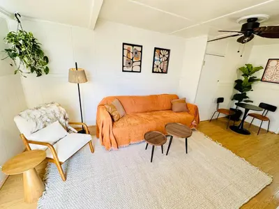 a living room with an orange couch and a rug at Casa Sol in San Diego
