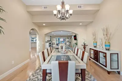 a dining room with a table and chairs and a chandelier at Oceanview Luxe Retreat with Rooftop in San Diego