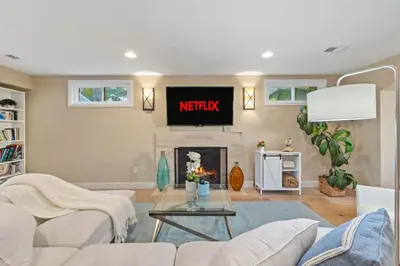a living room with a tv above a fireplace at Oceanview Luxe Retreat with Rooftop in San Diego